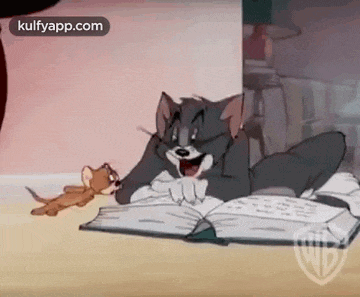 tom and jerry are laying on the floor reading a book together .