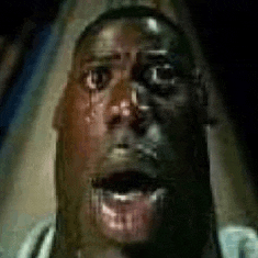 a close up of a man 's face with blood coming out of his eyes .