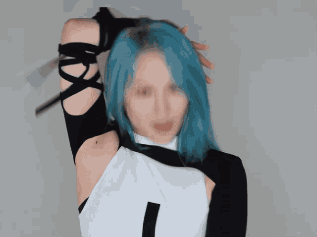 a woman with blue hair is wearing a white top and black sleeves