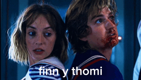 a man and a woman standing next to each other with finn y thomi written on the bottom right
