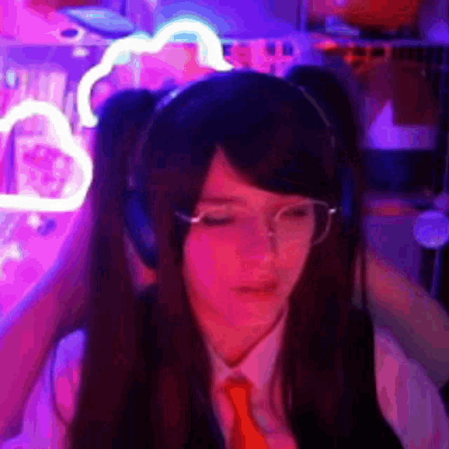 a girl wearing headphones and a tie is looking down