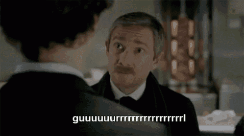 a man with a mustache is talking to another man in a suit and tie with the words guuuuuuurr written on the bottom