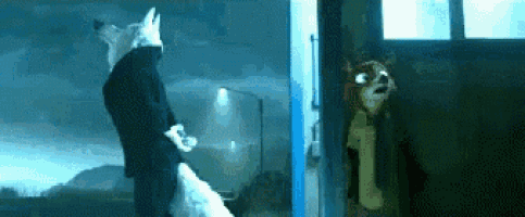a man in a suit is standing next to a dog in a doorway .