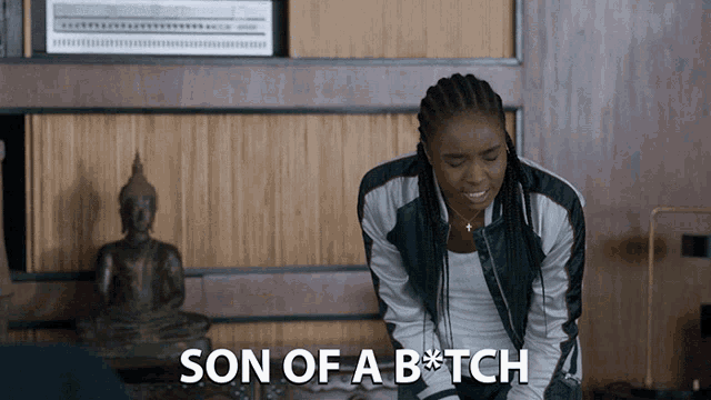 a woman is kneeling down with the words son of a b * tch behind her