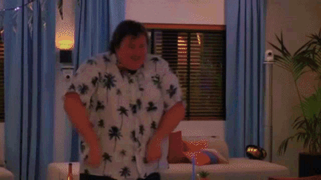 a man and woman are dancing in a living room .