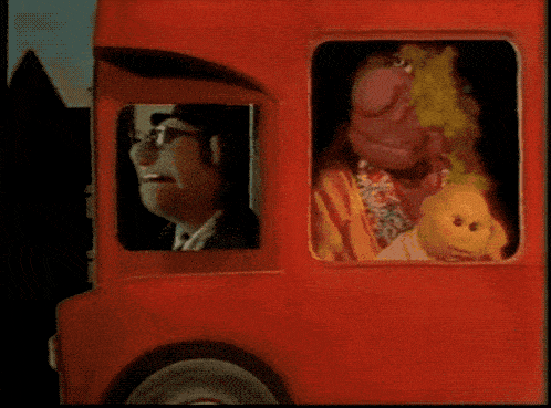 a man in a red hat is driving a red truck