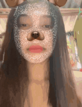 a woman wearing a dog mask on her face .