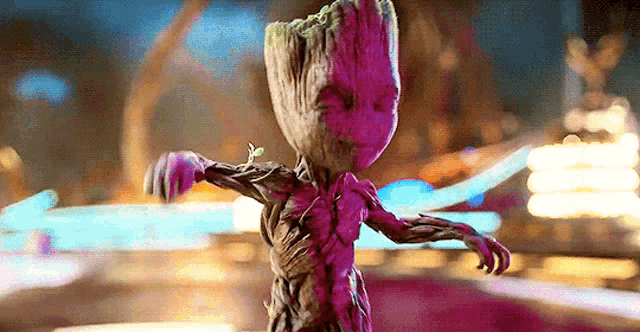 a baby groot from guardians of the galaxy is dancing in a carnival .