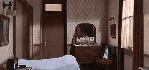 a bedroom with a bed , dresser and mirror