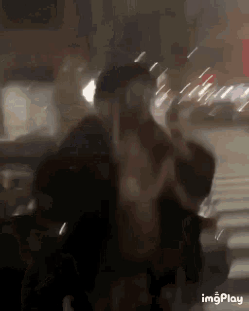 a blurry photo of a man giving the middle finger