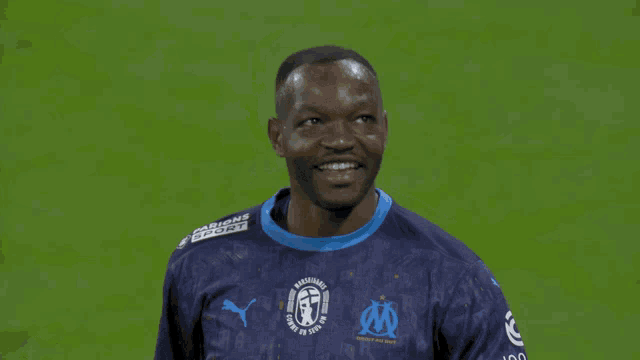 a man wearing a blue jersey with uber on the front