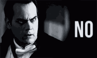 a man in a tuxedo and bow tie says no in a black and white photo