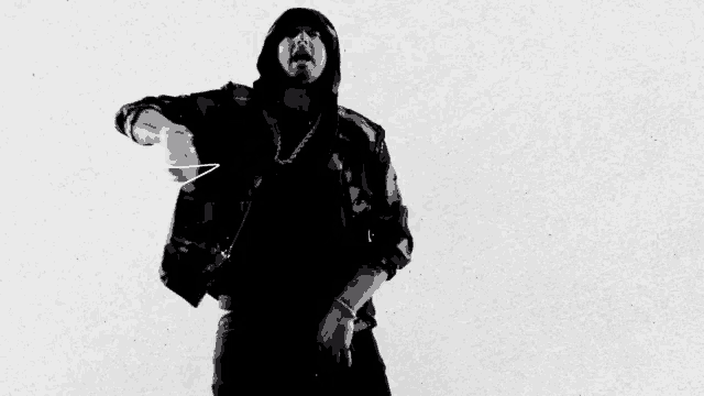 a black and white photo of a man wearing a hoodie