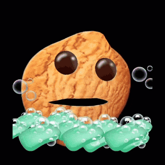 a cookie with a face is surrounded by green soap bubbles on a black background