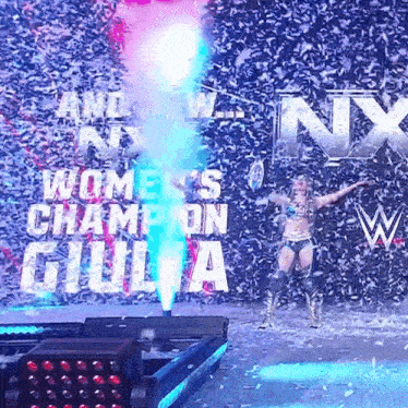 a woman stands in front of a sign that says ' women 's champion giulia ' on it