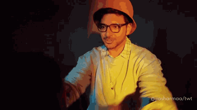 a man wearing glasses and a hat with the hashtag jiasharmaa/twt