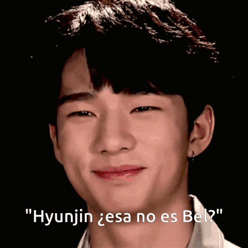a close up of a person 's face with the words " hyunjin esa no es bel " written below it