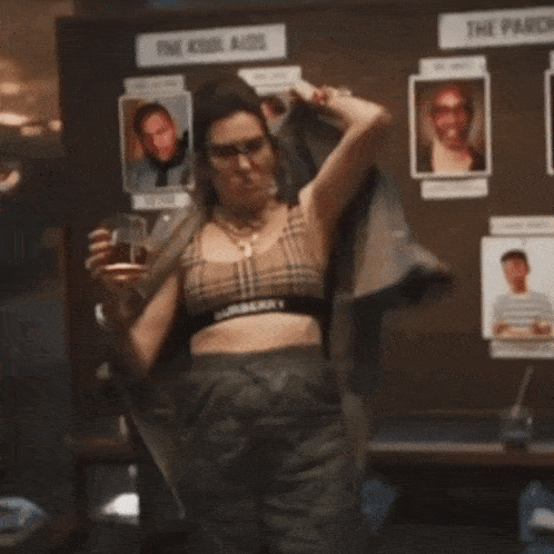 a woman is pointing at a sign that says the kool aids