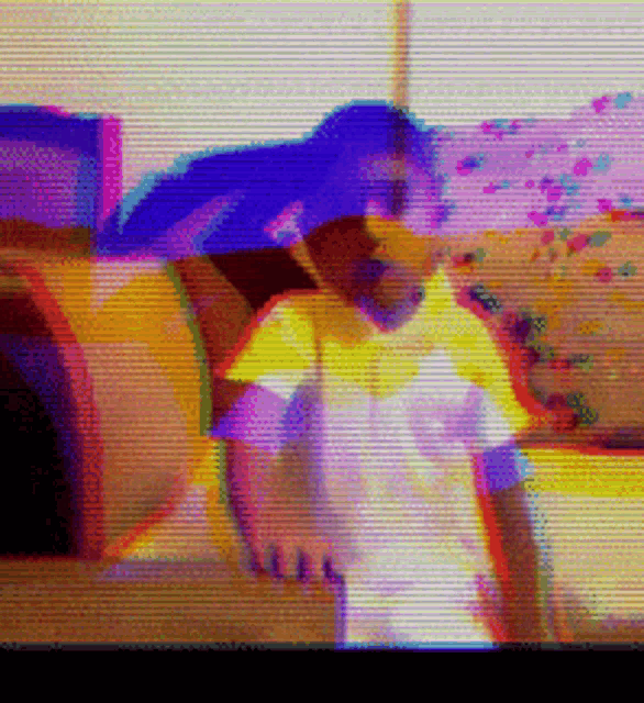 a blurred image of a person sitting on a couch
