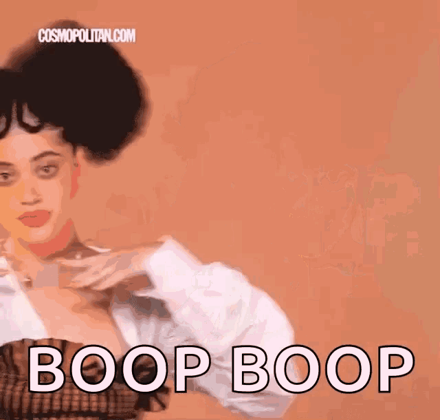 a woman with a big afro says boop boop in front of a cosmopolitan.com logo