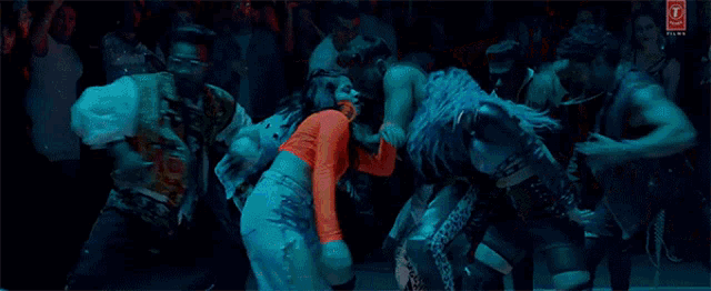 a group of people are dancing in front of a crowd in a dance studio .