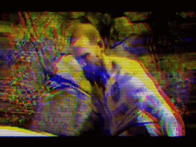 a blurry picture of a man with a purple shirt on