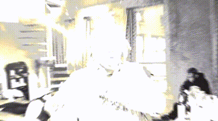 a man with green hair is standing in a room with his hands on his chest