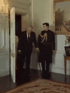 a man with a cane is standing next to another man