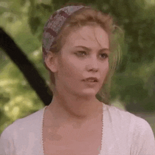 a woman is wearing a headband and a white shirt .