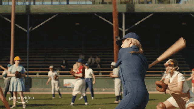 a girl is swinging a bat on a baseball field with a prime video logo in the background