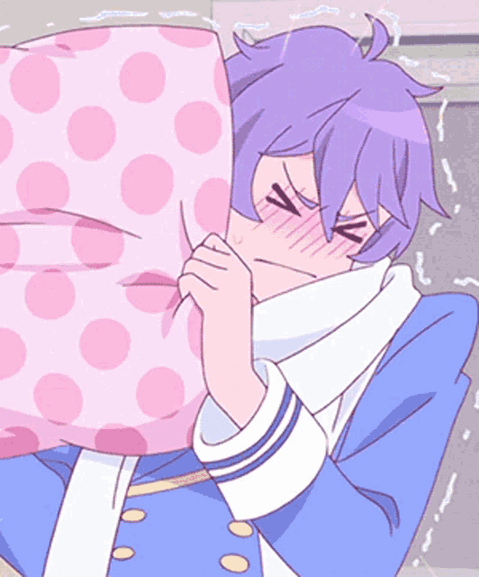 a boy with purple hair is holding a pink polka dot pillow over his face