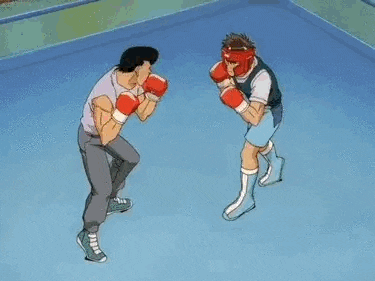 a boxing ring with a red rope and a punching bag