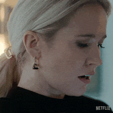 a close up of a woman 's ear with a netflix logo in the background