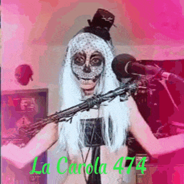a woman in a day of the dead costume is holding a microphone and wearing a top hat .