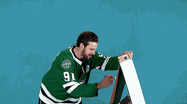 a man in a green jersey with the number 91