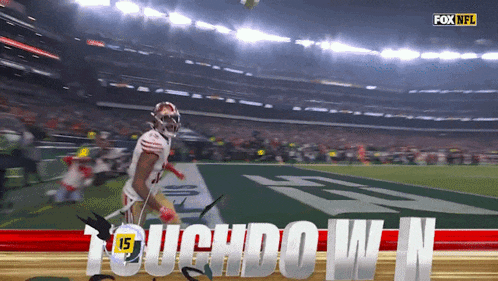 a football player is running on the field with the words touchdown n behind him