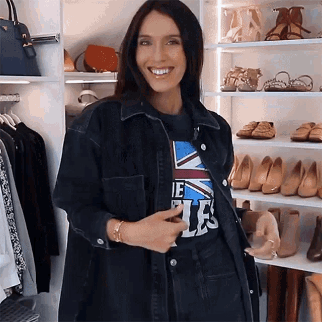 a woman wearing a t-shirt that says the beatles is smiling
