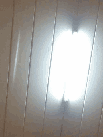 a white wall with a light on the bottom of it