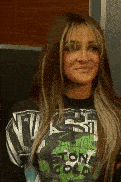 a woman wearing a shirt that says west stone cold on it