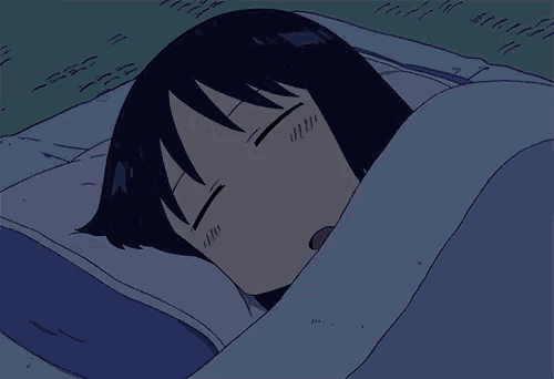 a girl is sleeping in a bed with a blue blanket