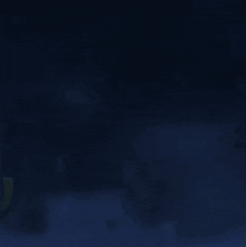 a close up of a person 's face in the dark with a scarf on their head .