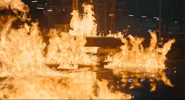 a large fire is burning in a dark room