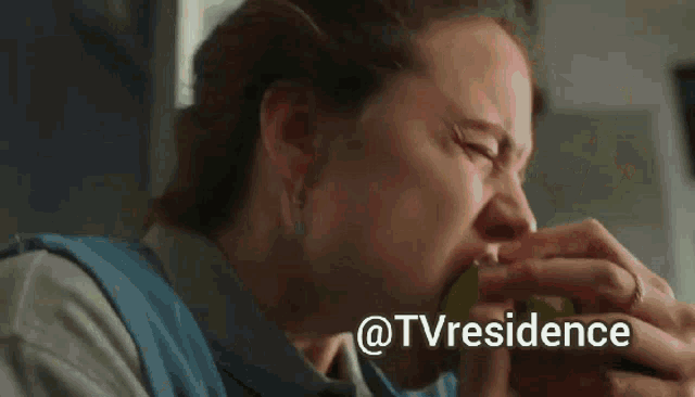 a woman eating a green apple with the words @tvresidence above her