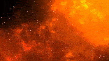a fire with sparks coming out of it on a black background