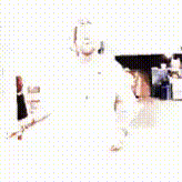 a man with a beard is standing in a kitchen wearing a white hat