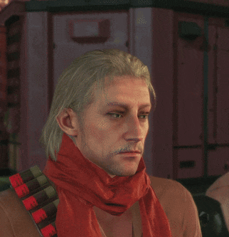 a man wearing a red scarf and a brown shirt looks at the camera
