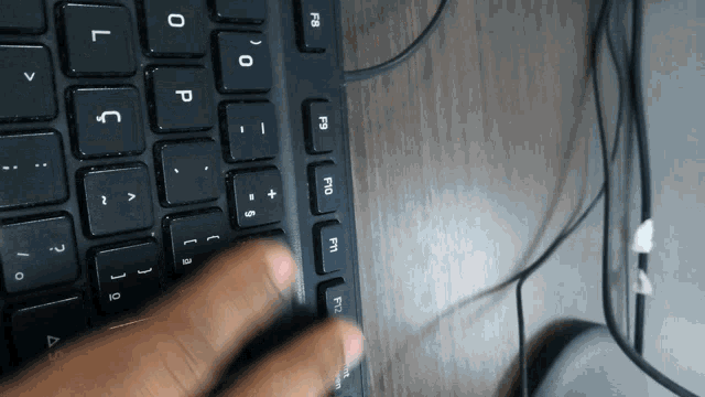 a person is typing on a keyboard with the keys f1 f2 and f3 highlighted