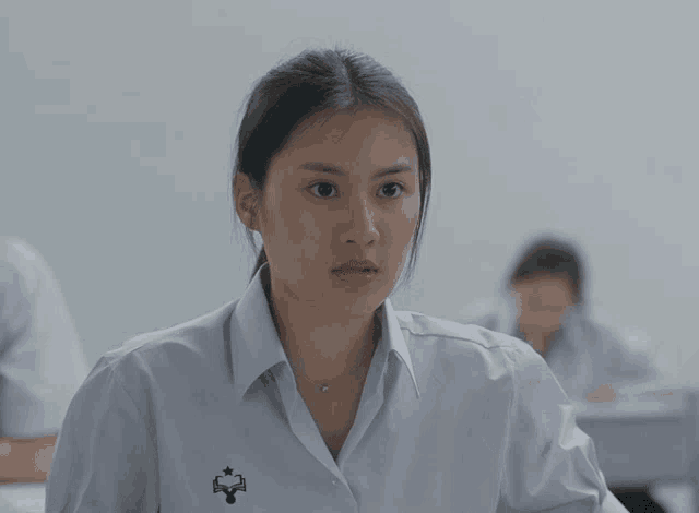 a girl wearing a white shirt with a star on the left shoulder