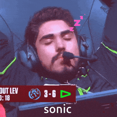 a man wearing headphones is sleeping in front of a sign that says sonic on it
