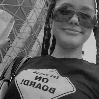 a woman wearing sunglasses and a shirt that says bitch